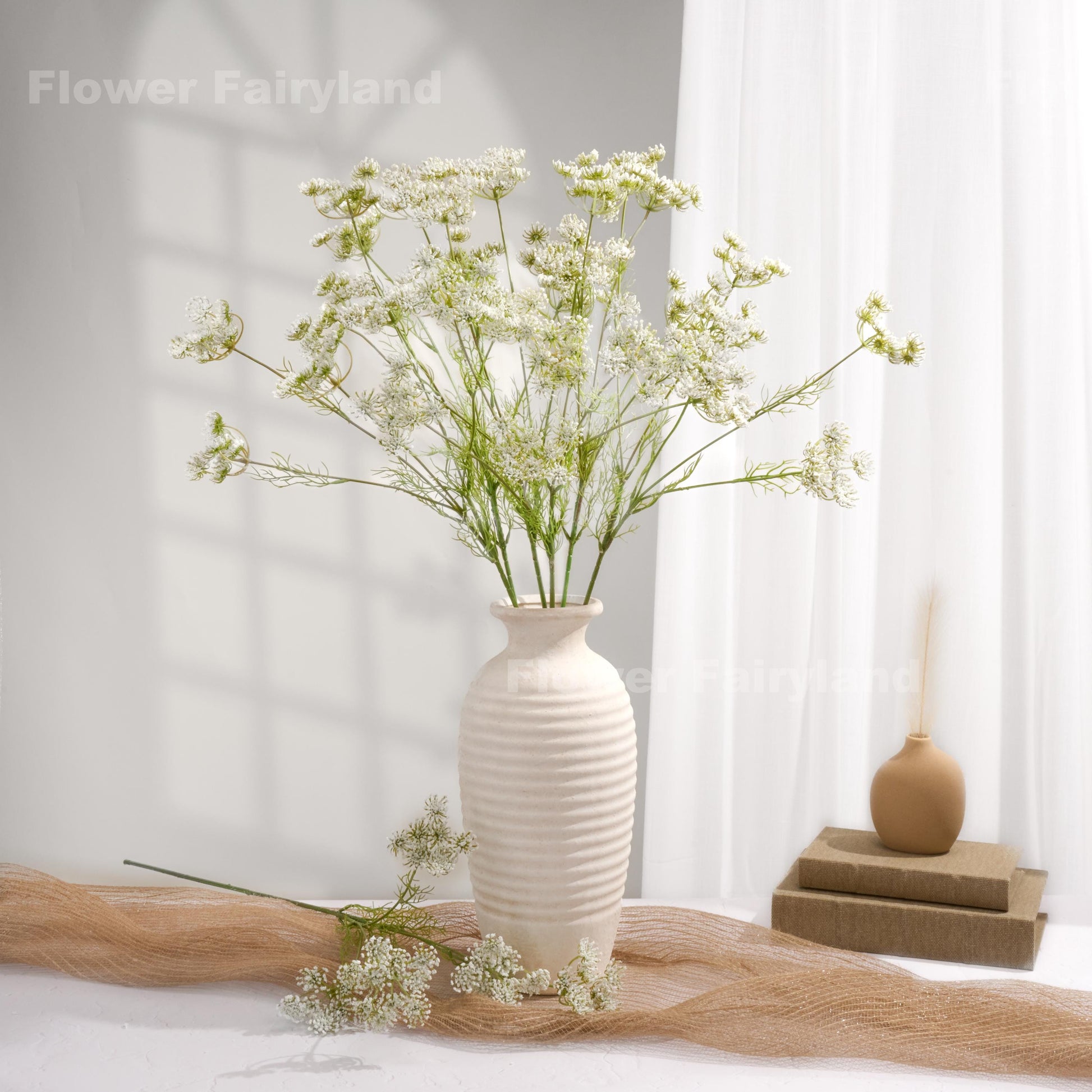 White faux Queen Anne's lace arrangement in a white vase