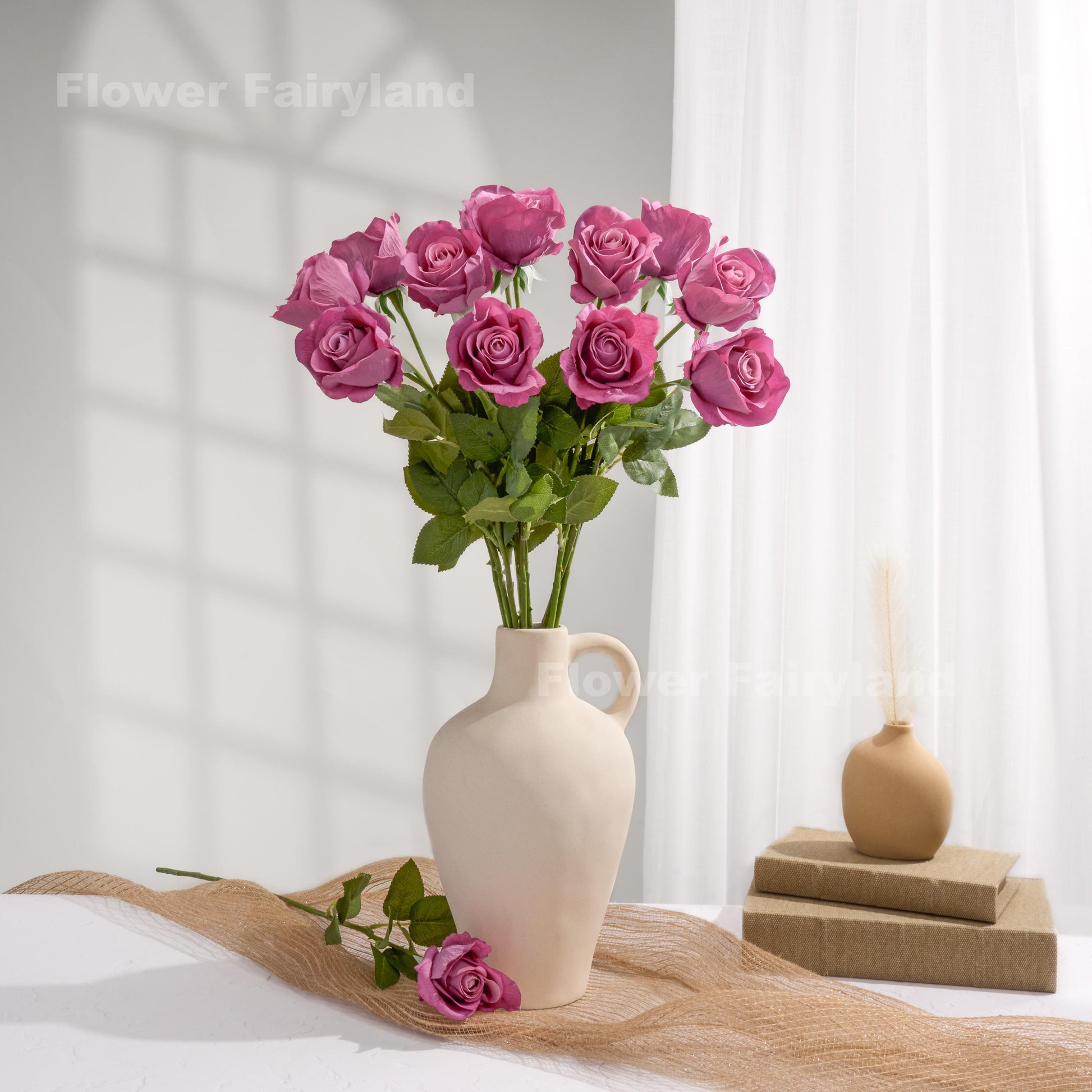 Mulberry roses styled in a cream vase
