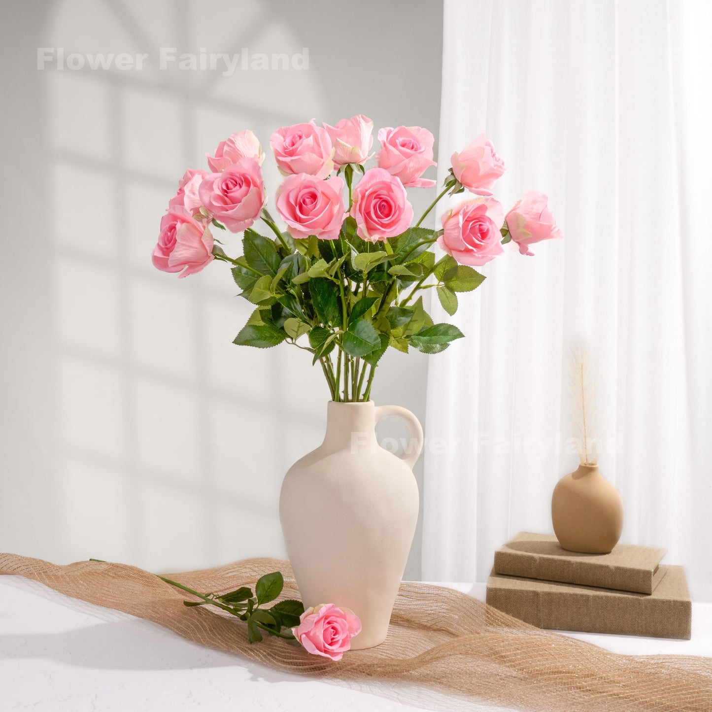 Pink roses styled in a cream vase