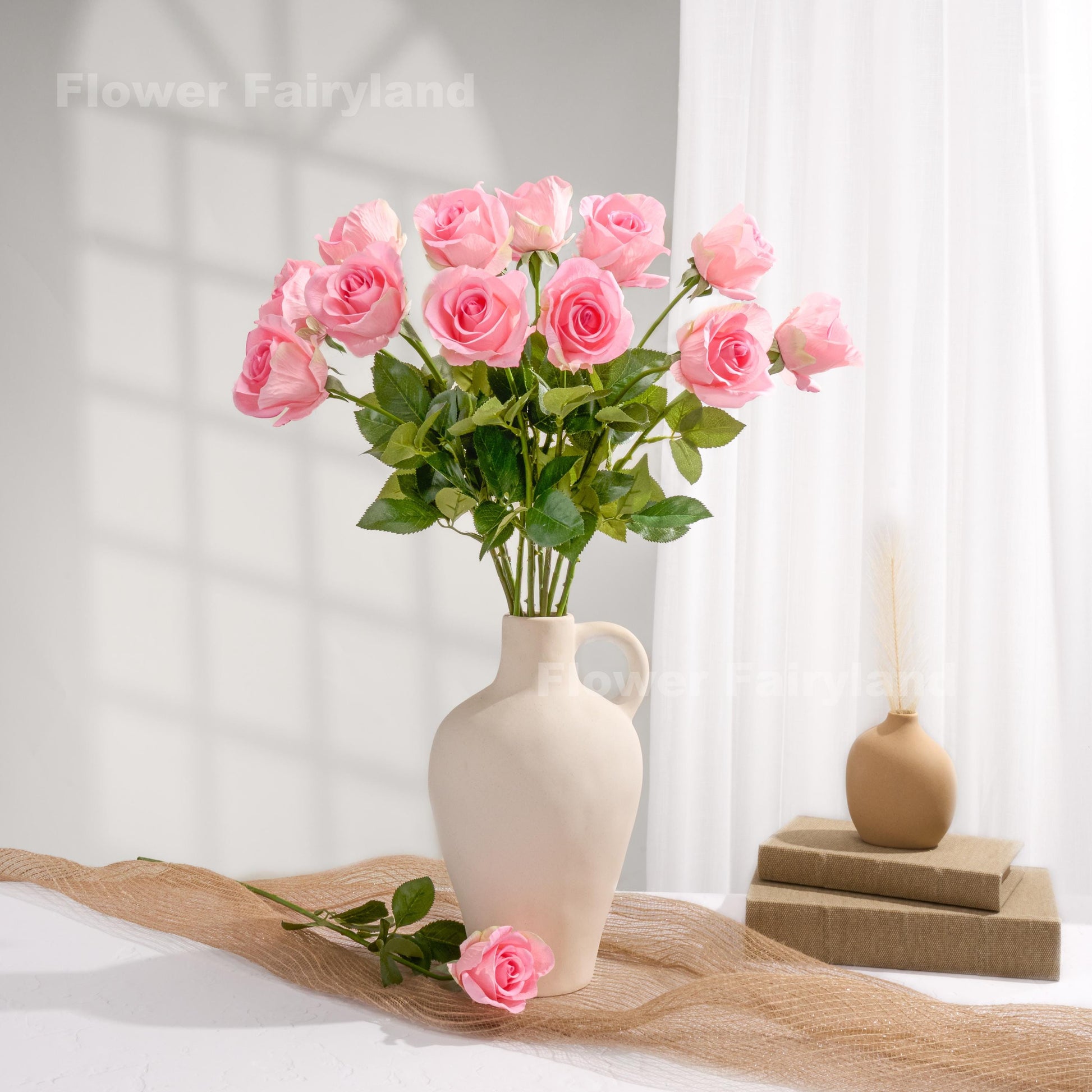 Pink roses styled in a cream vase