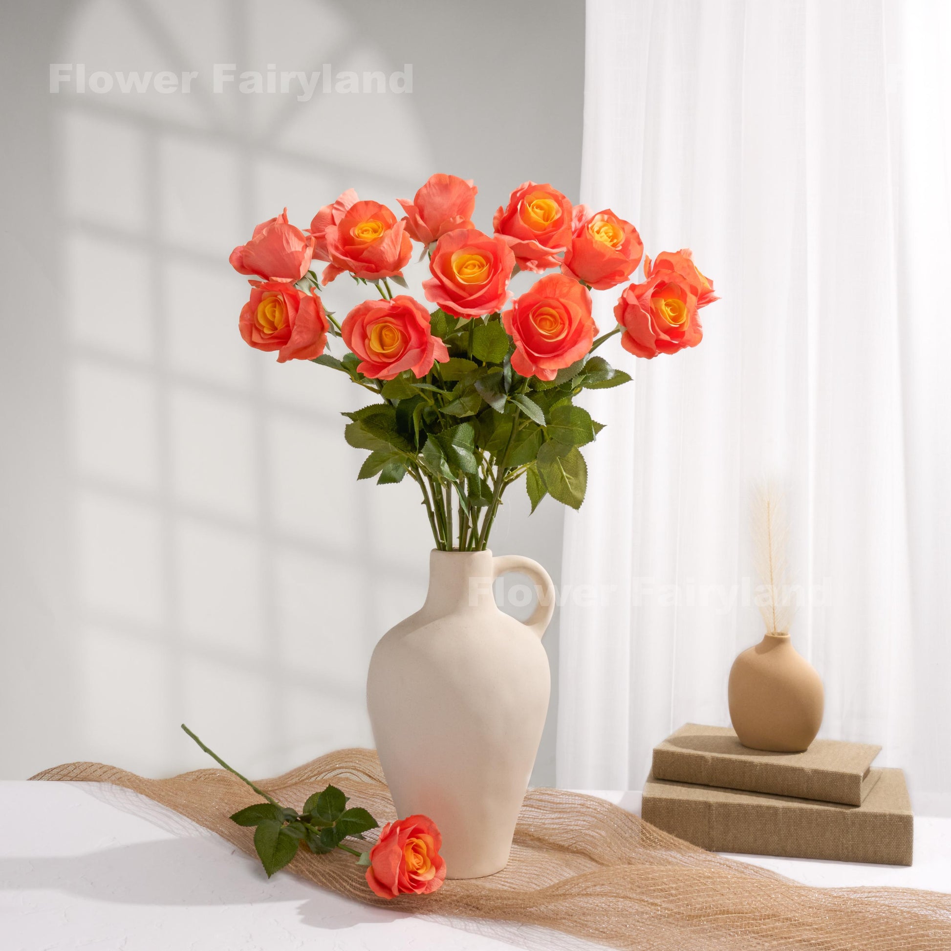 Orange ombre roses styled in a cream vase