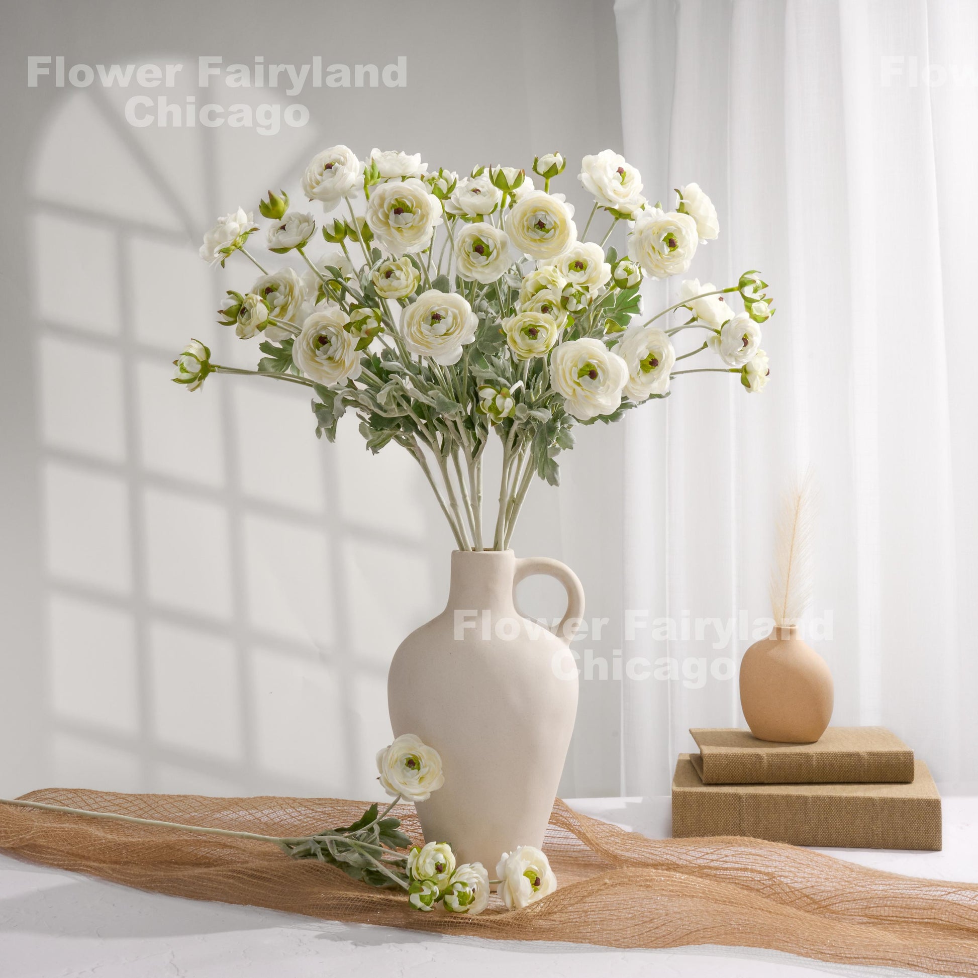 White faux ranunculus stems in a vase