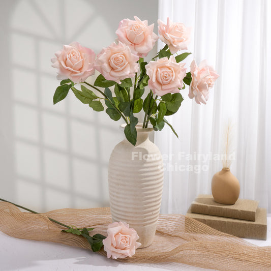 Pale pink roses styled in a vase