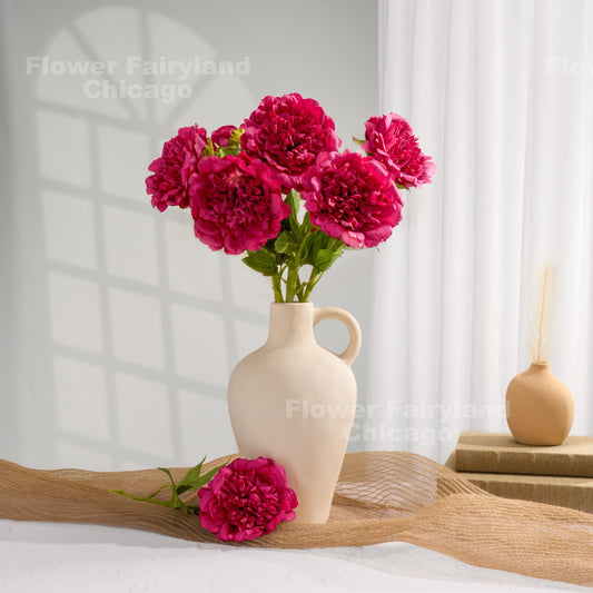 Raspberry faux peonies styled in a home decor scene