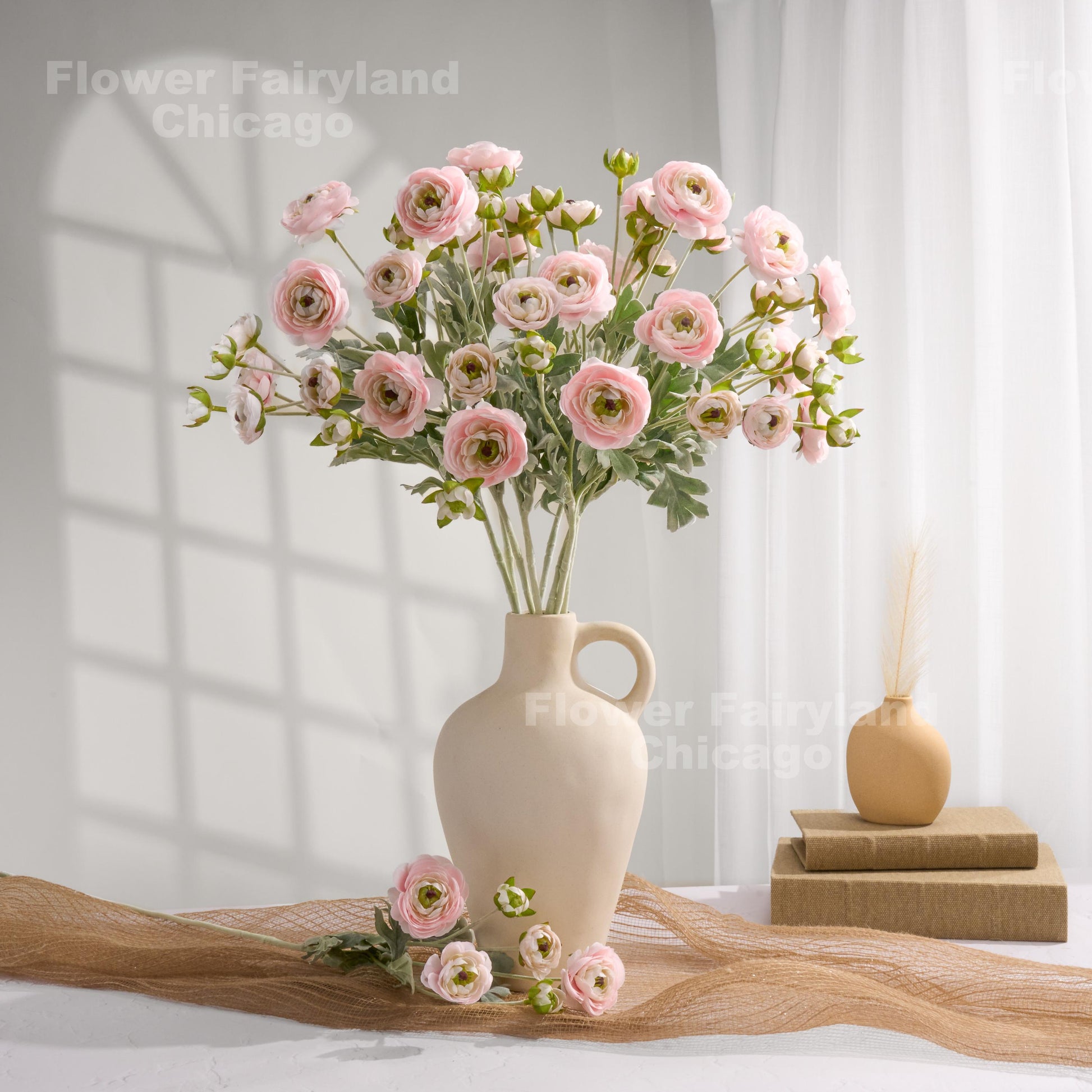 Soft pink faux ranunculus stems in a vase