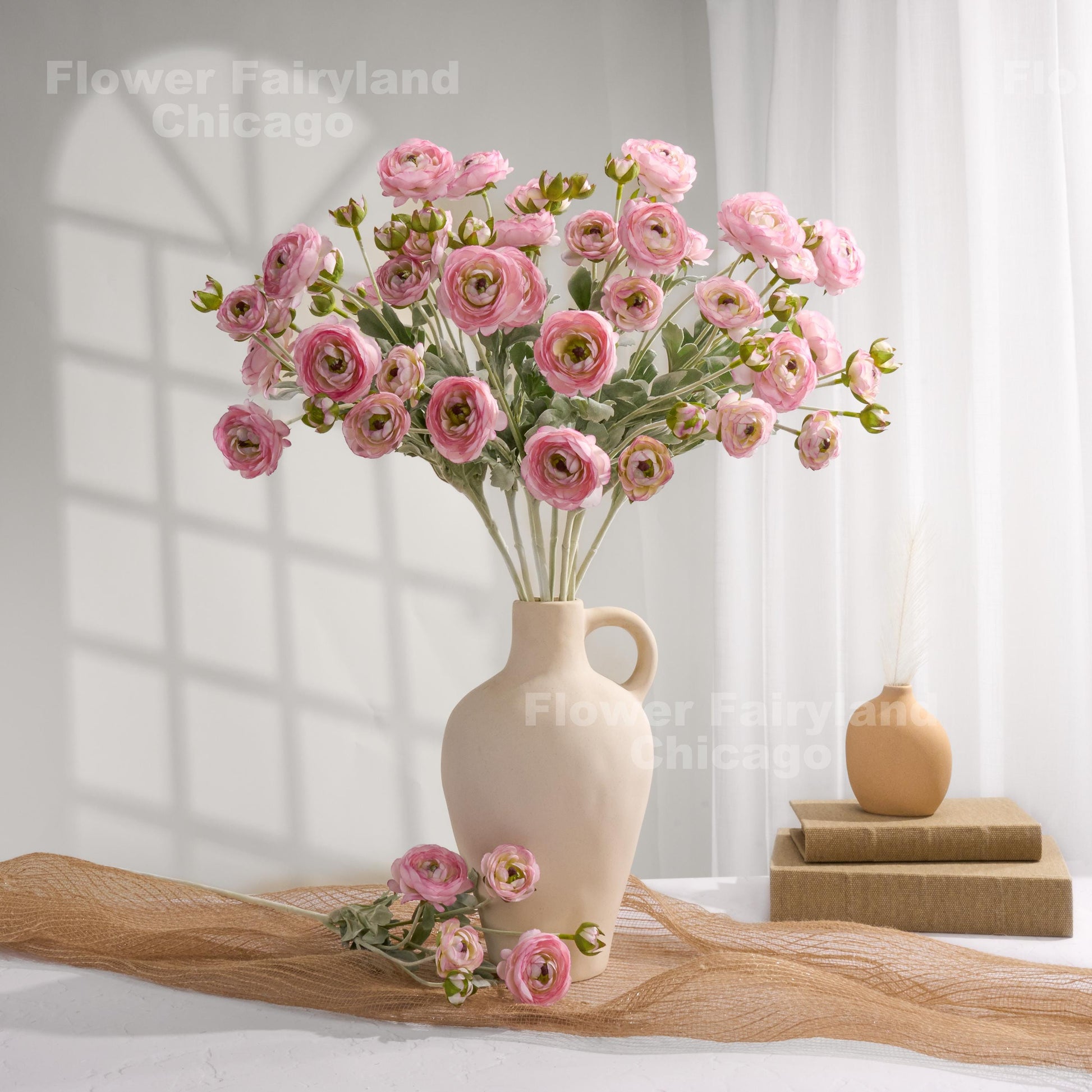 Pink faux ranunculus stems in a vase