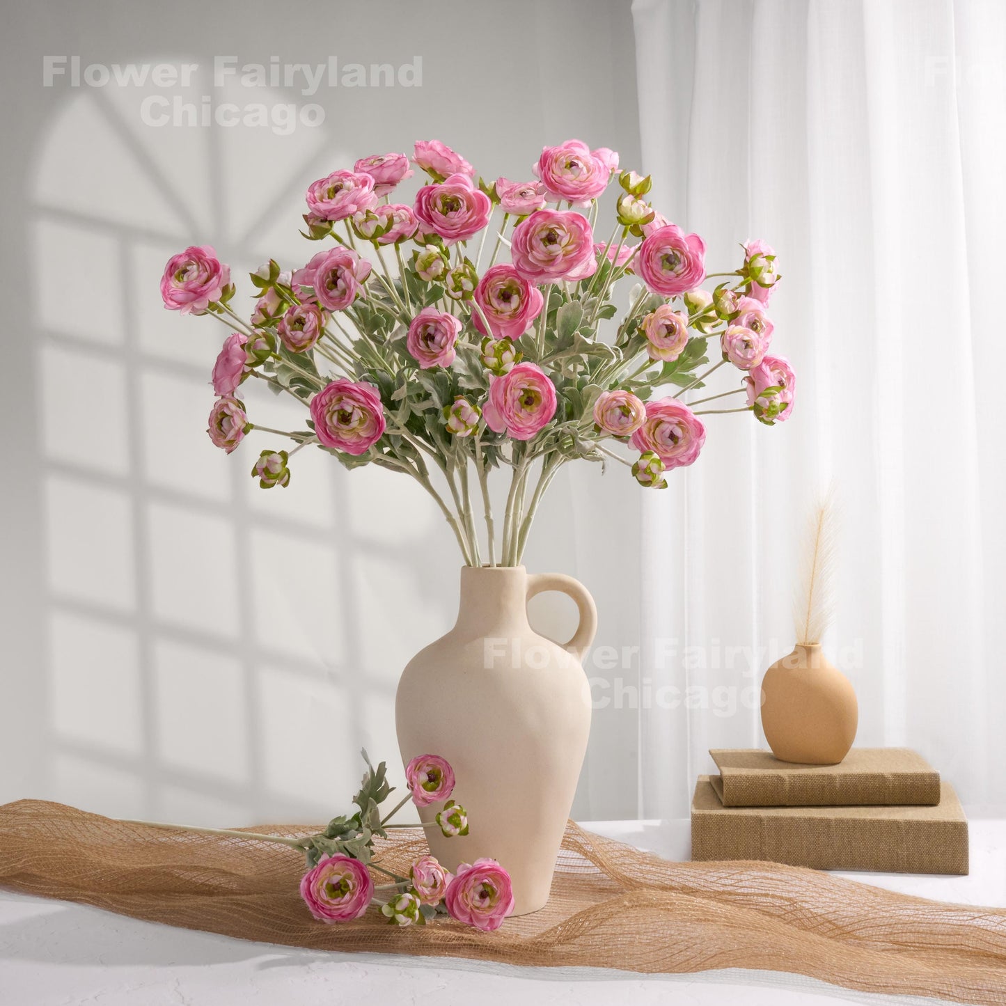 Pretty pink faux ranunculus stems in a vase
