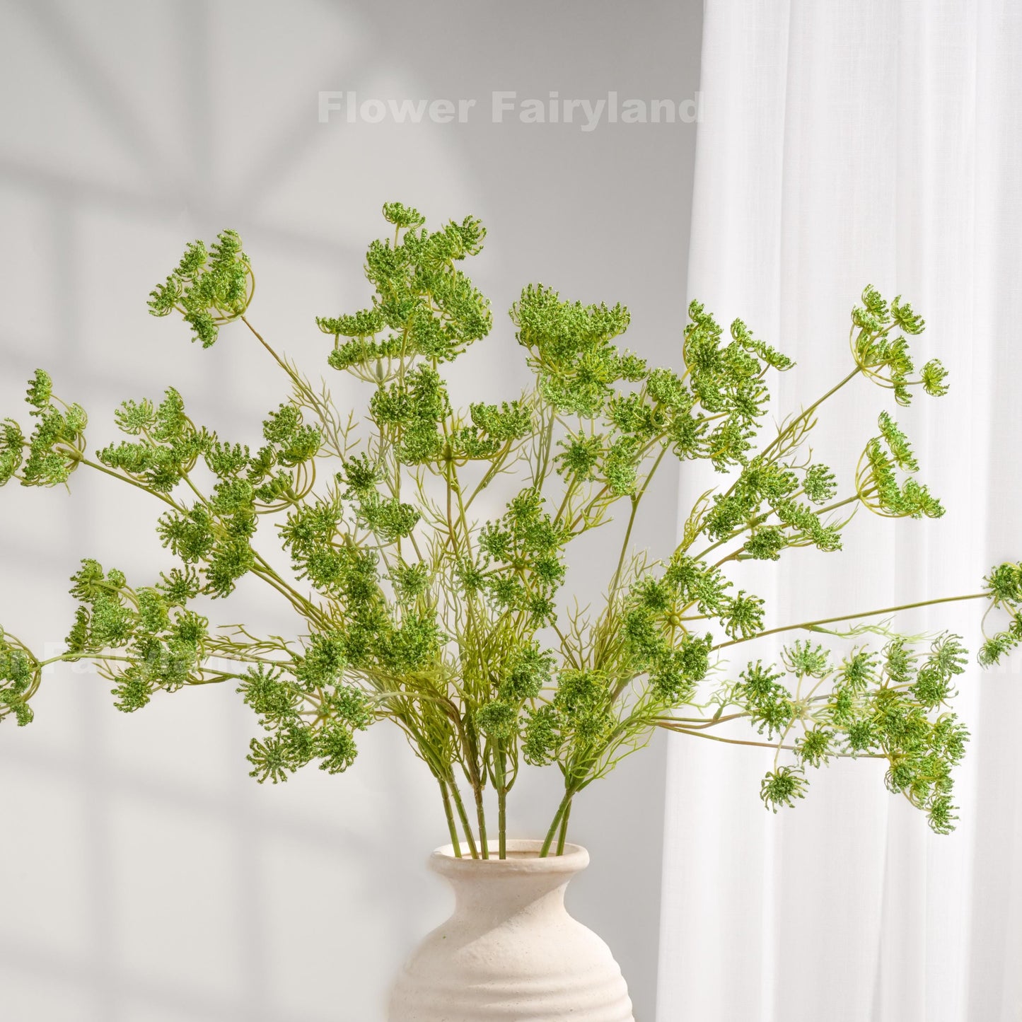 Green faux Queen Anne's lace stems styled in a vase