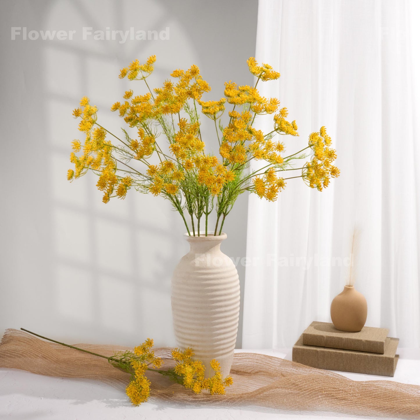 Yellow faux Queen Anne's lace arrangement in a white vase