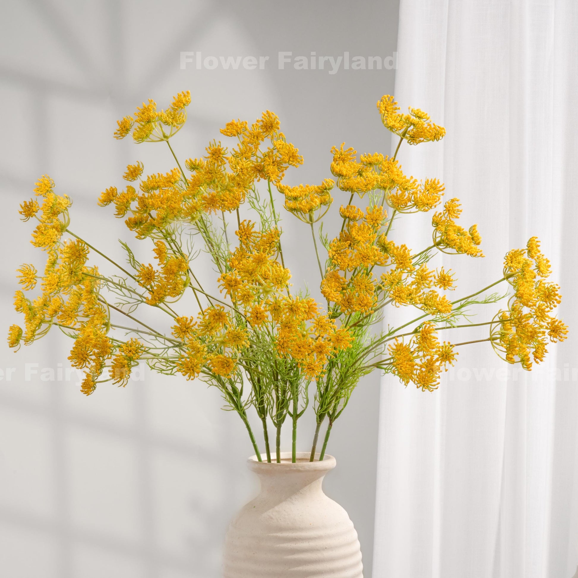 Yellow faux Queen Anne's lace stems styled in a vase