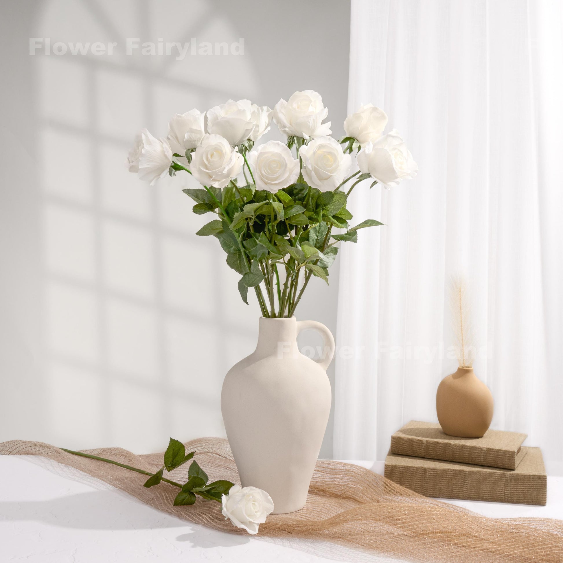 White roses styled in a cream vase