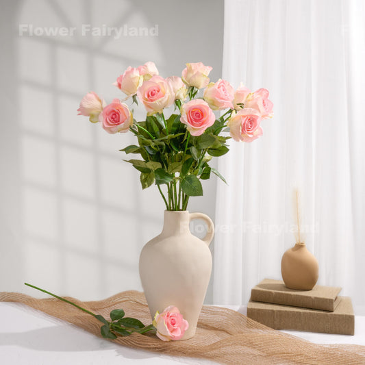 Light greenish pink roses styled in a cream vase