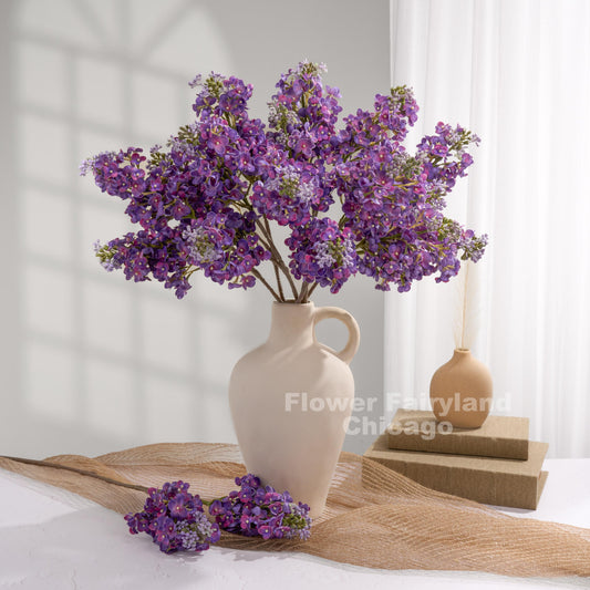 Dark purple lilac arrangement in vase