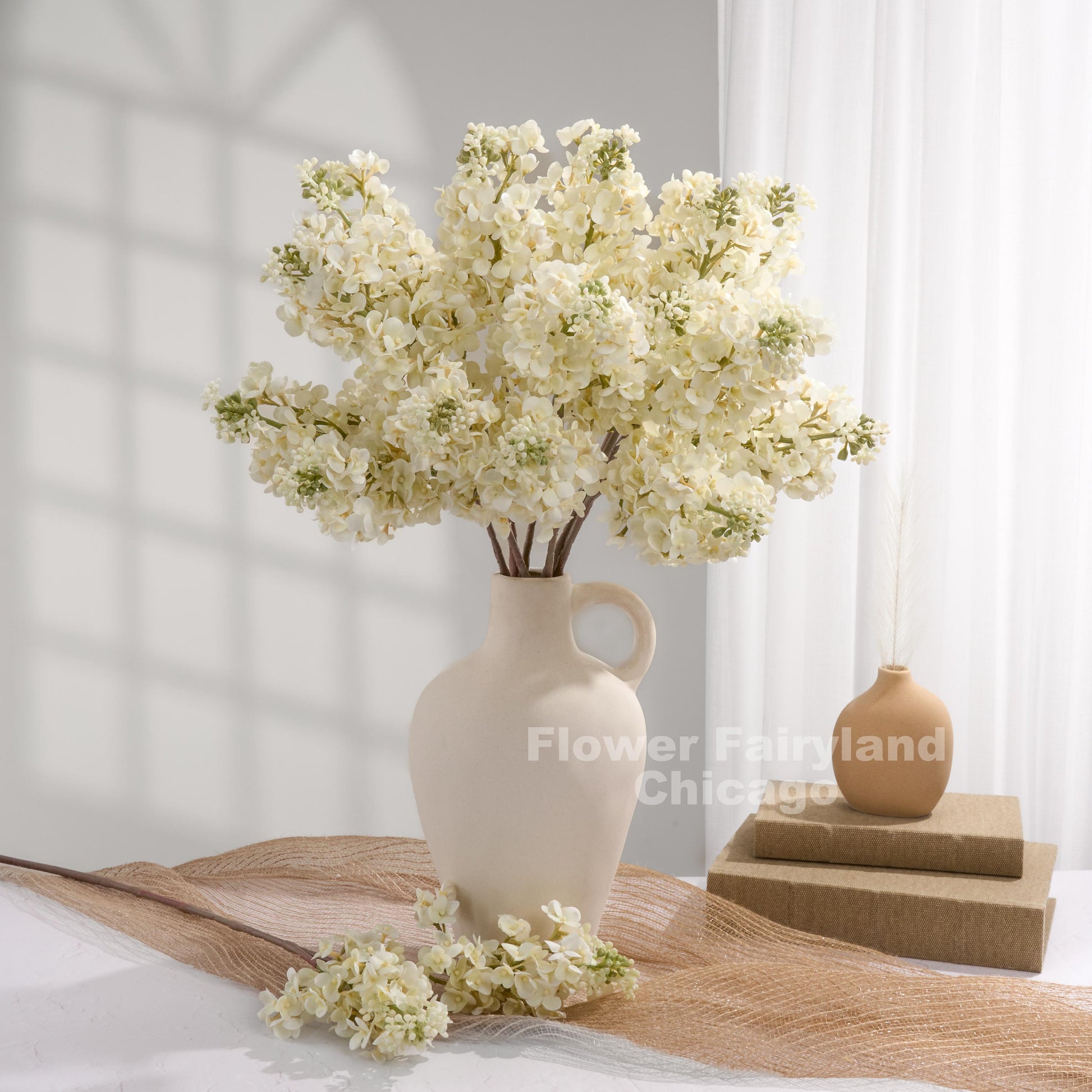 Ivory real touch lilac stems in a vase