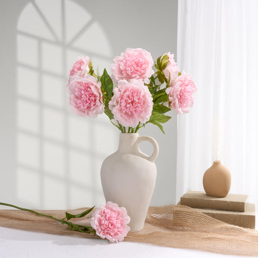 Baby pink faux peonies styled in a home decor scene