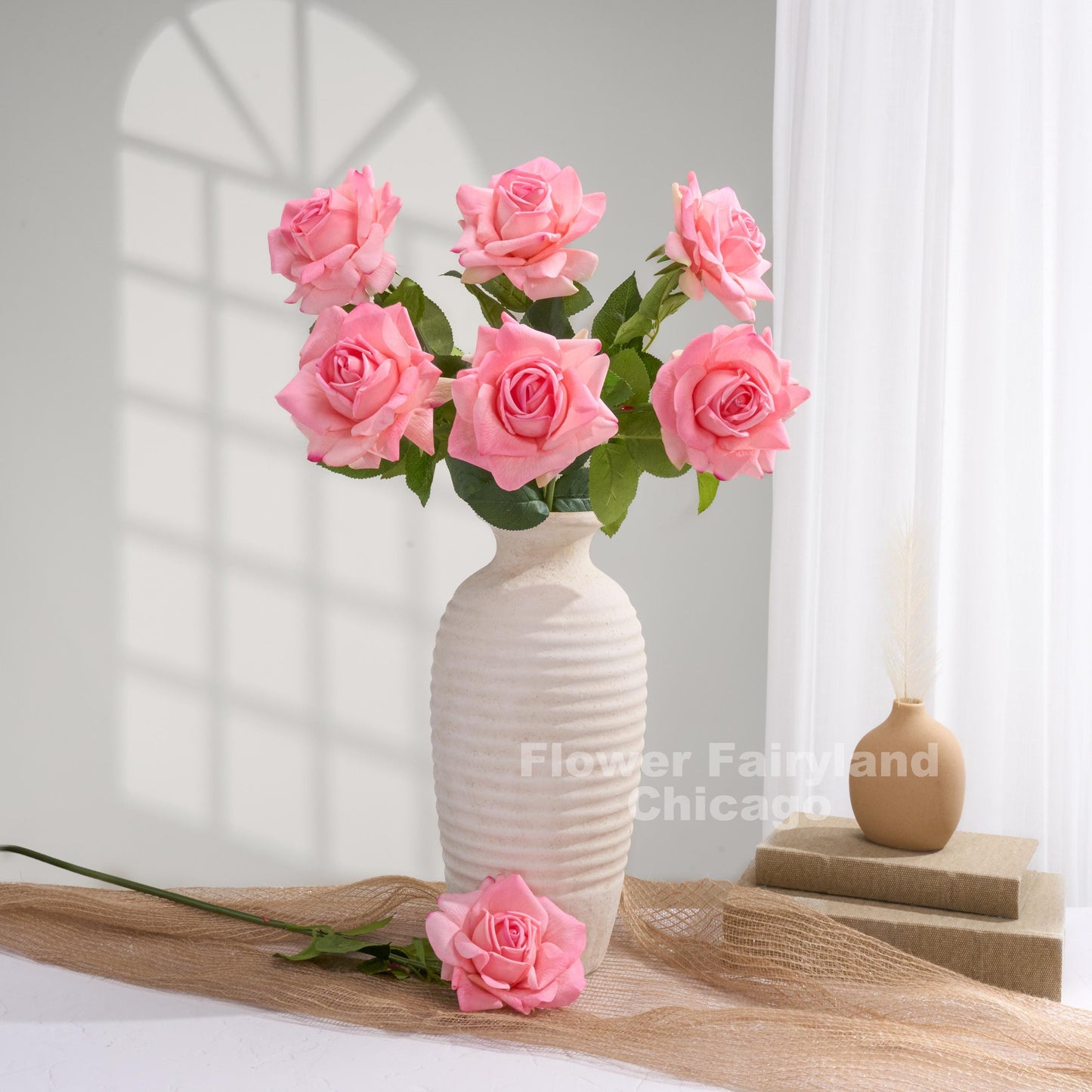 Lipstick pink roses styled in a vase