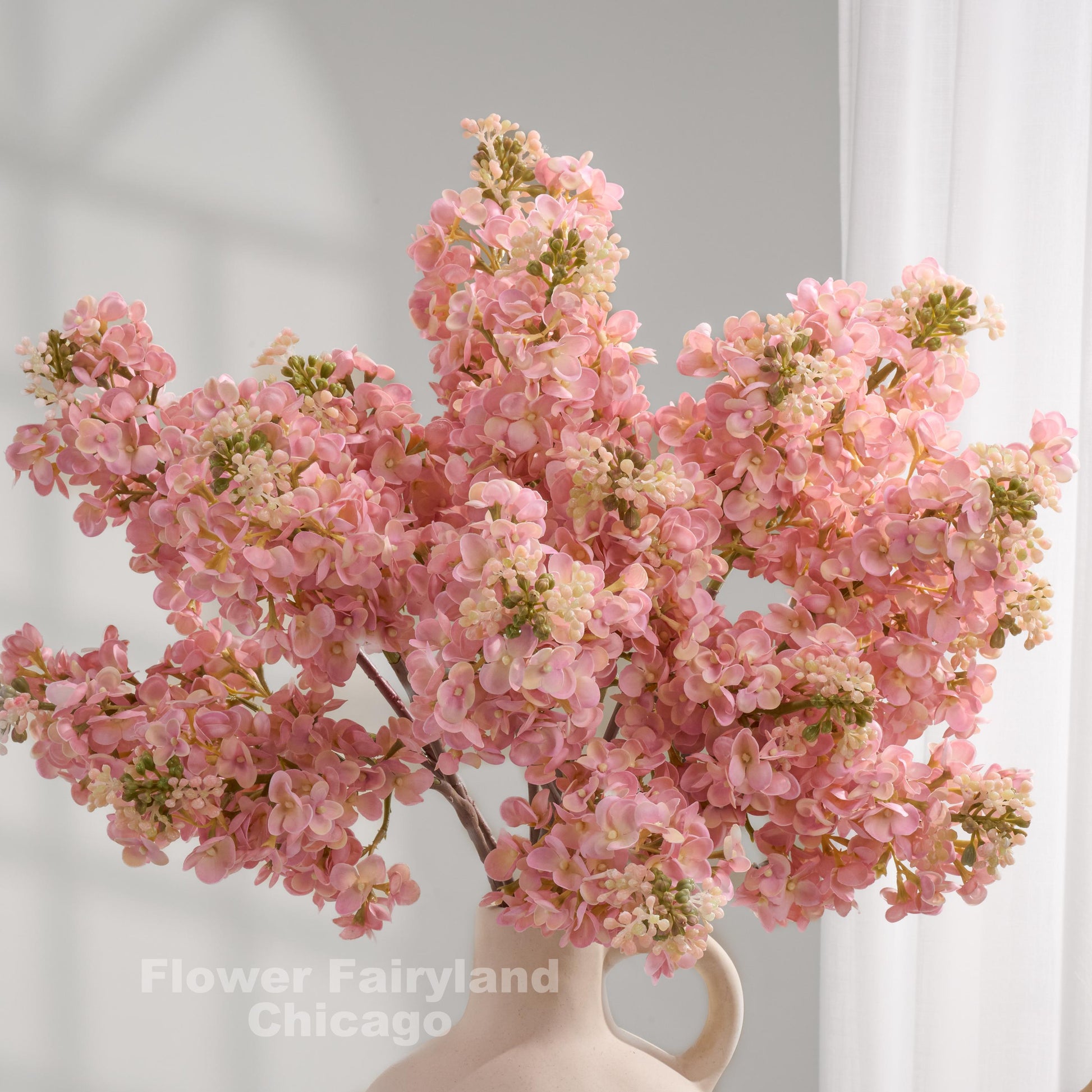 Light pink real touch lilac stems in a vase