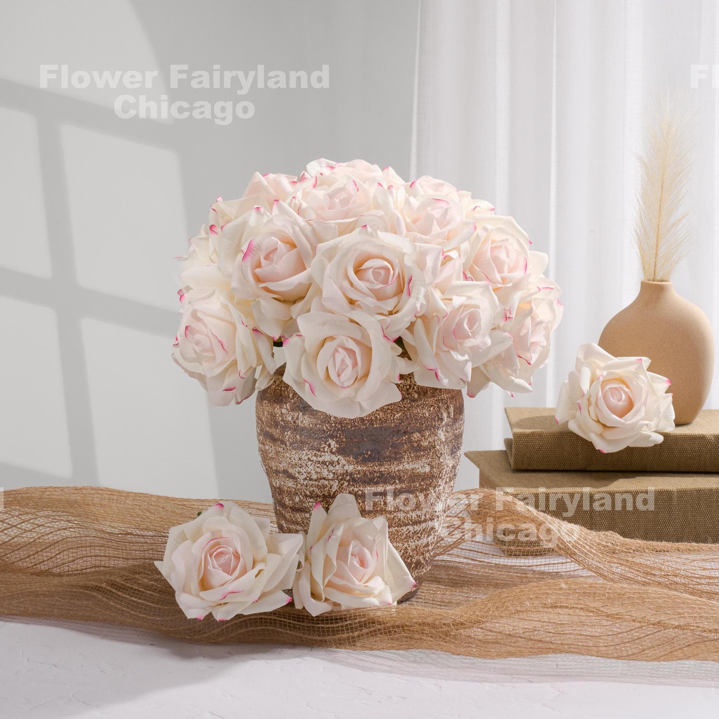 Cream roses with pink edges arranged in vase