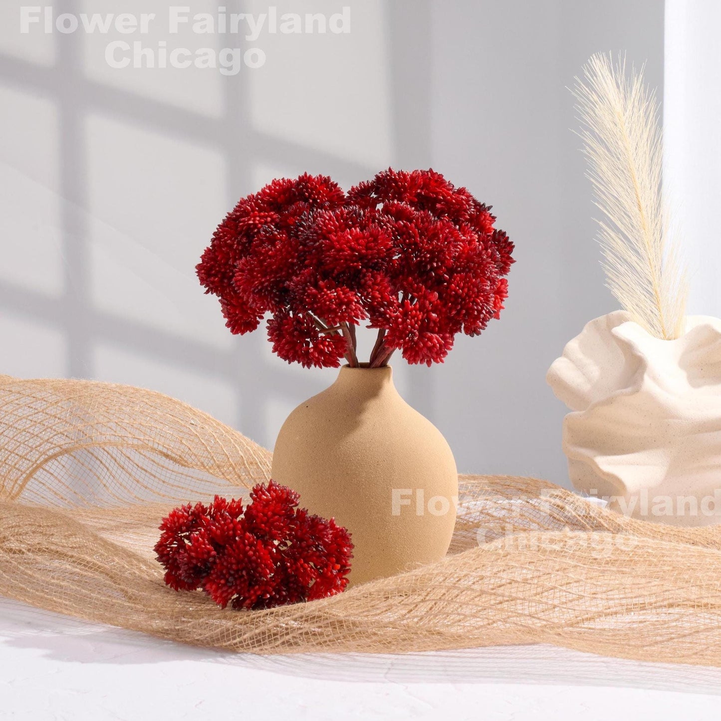 Red sedum cluster arrangement in a vase