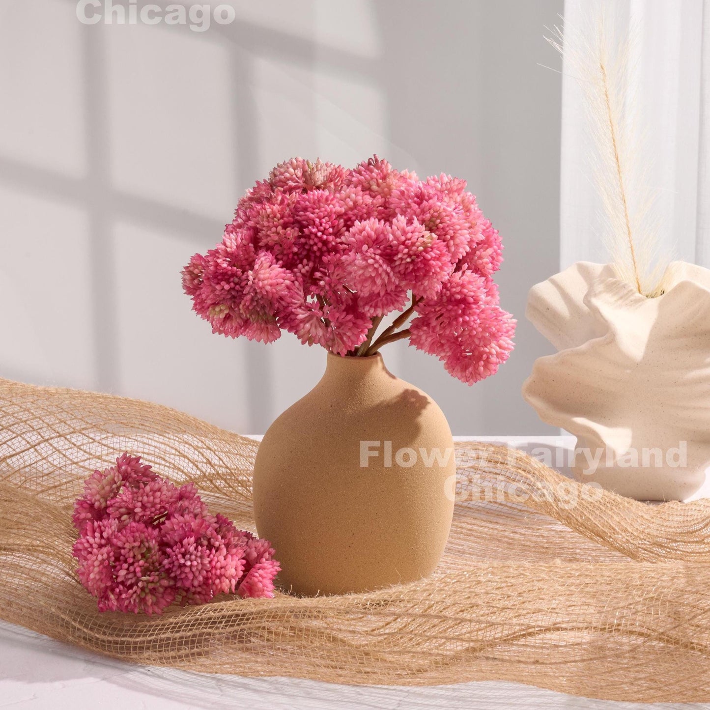Pinkish mauve sedum cluster arrangement in a vase