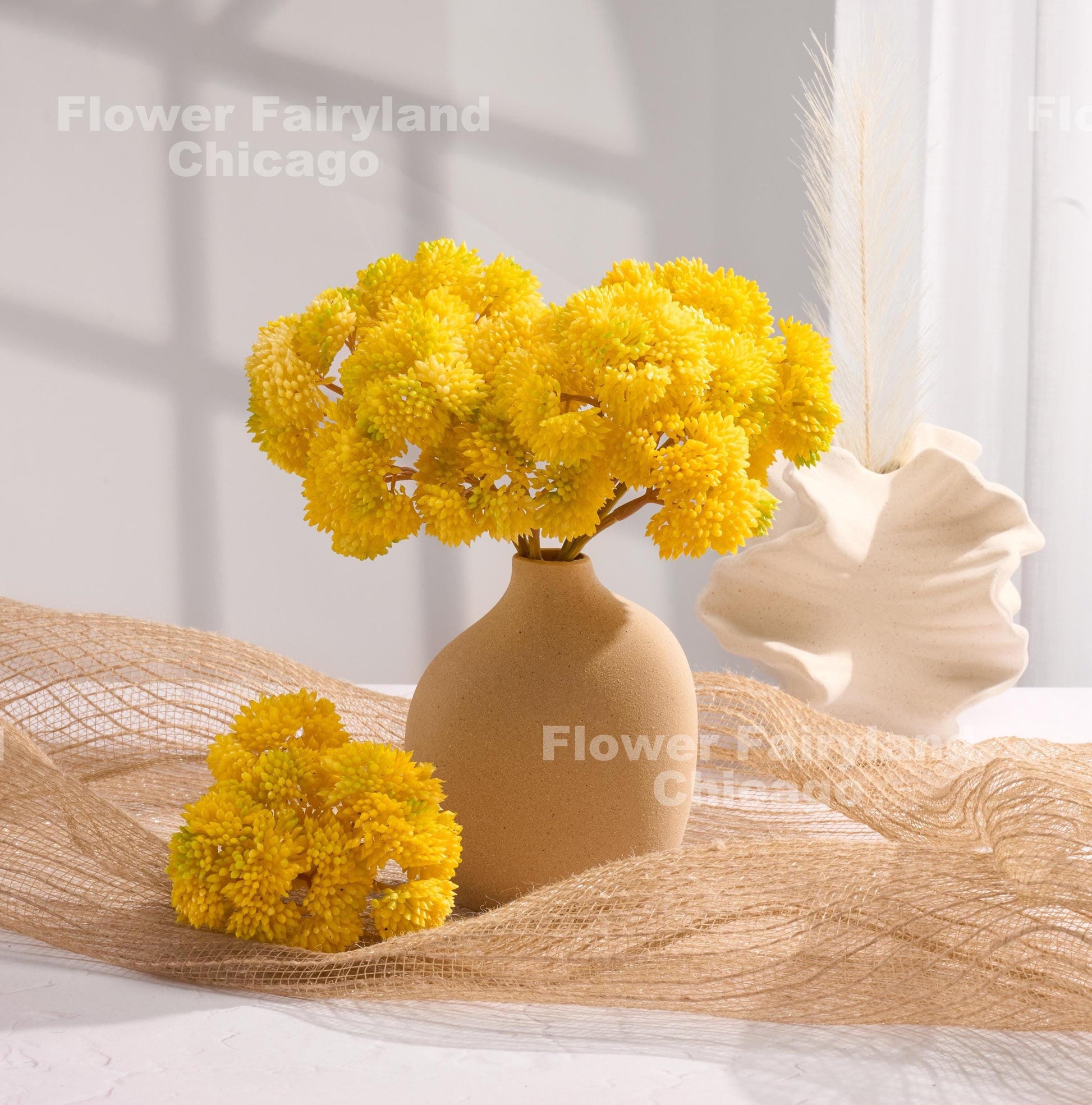 Yellow sedum cluster arrangement in a vase