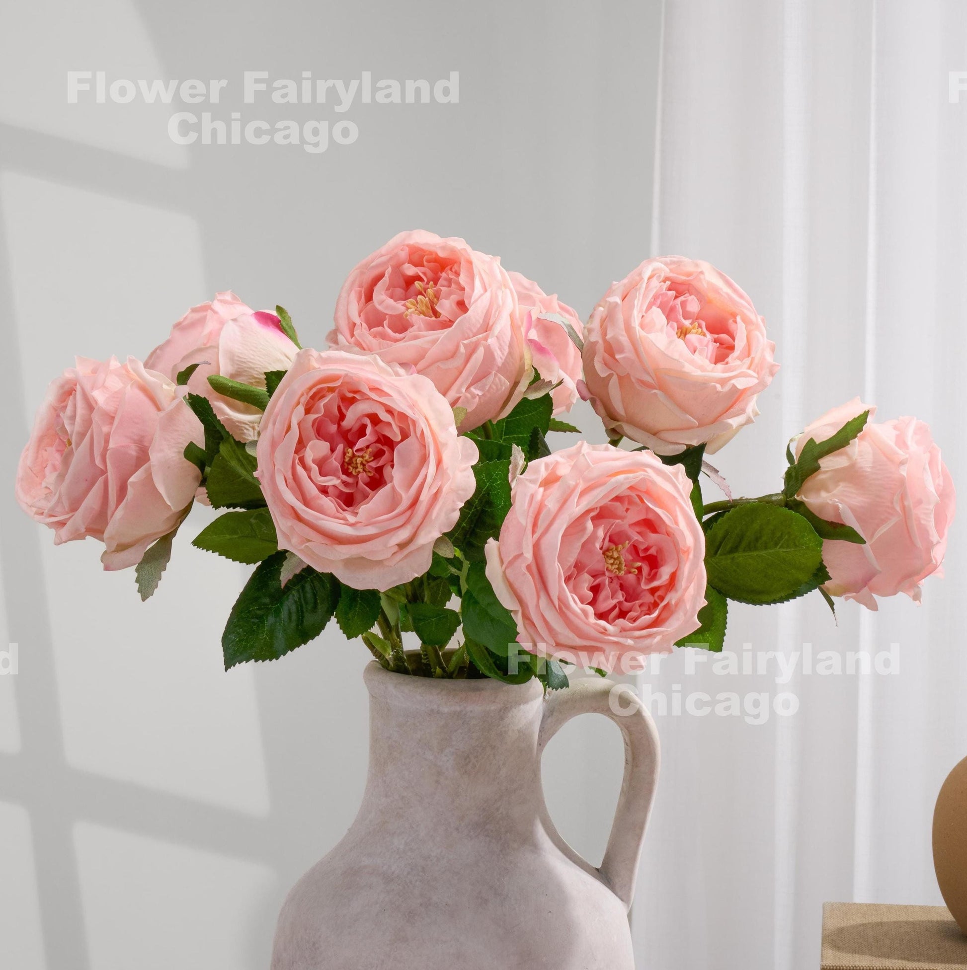 Light pink David Austin roses in a vase
