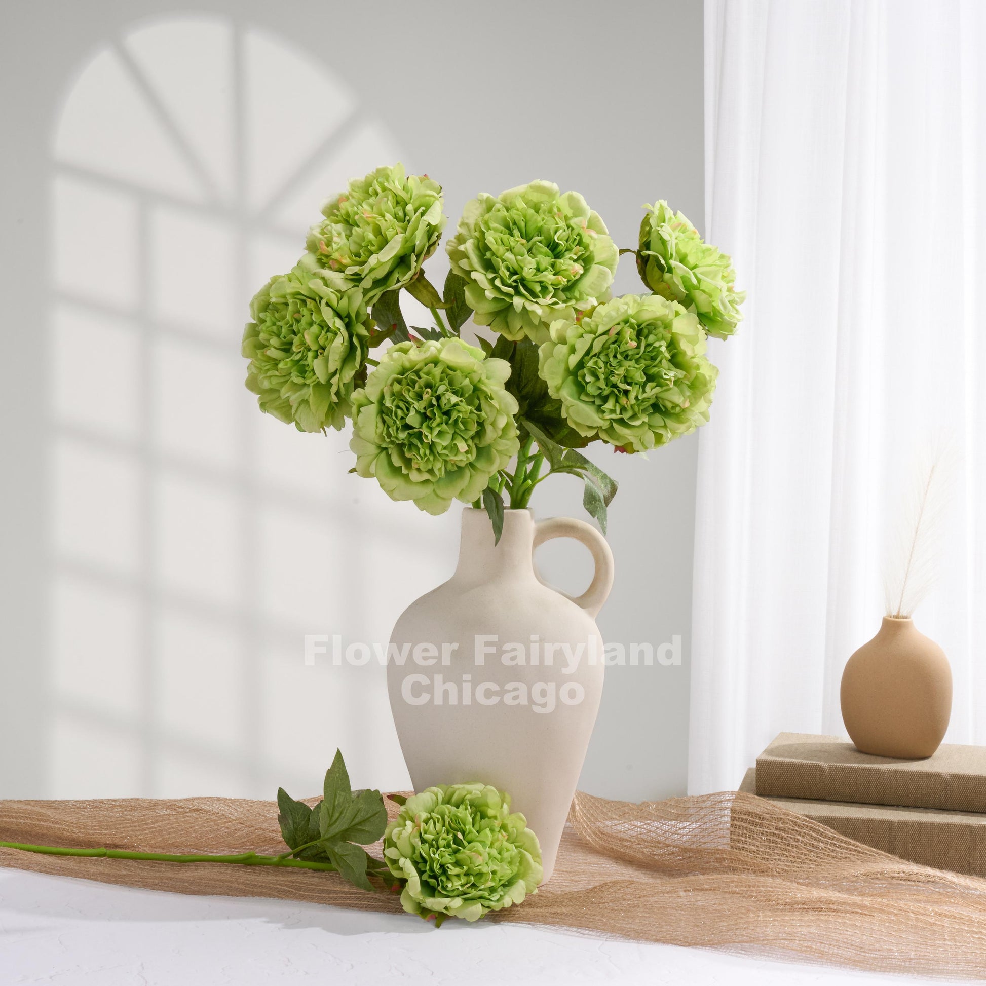 Green faux peonies styled in a home decor scene