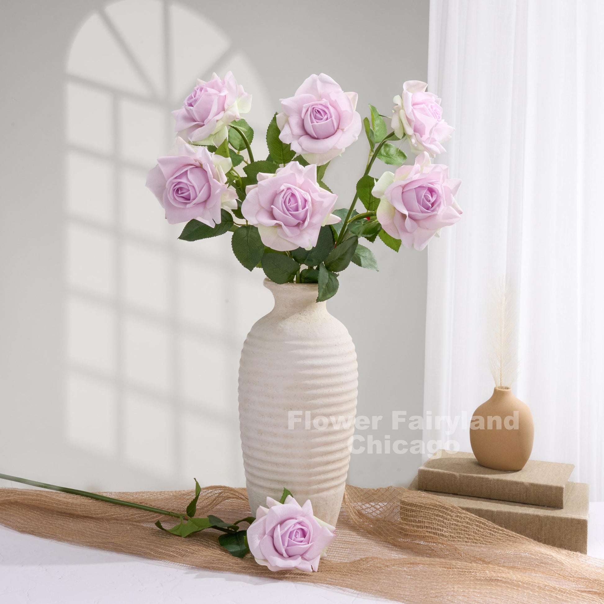Soft purple roses styled in a vase