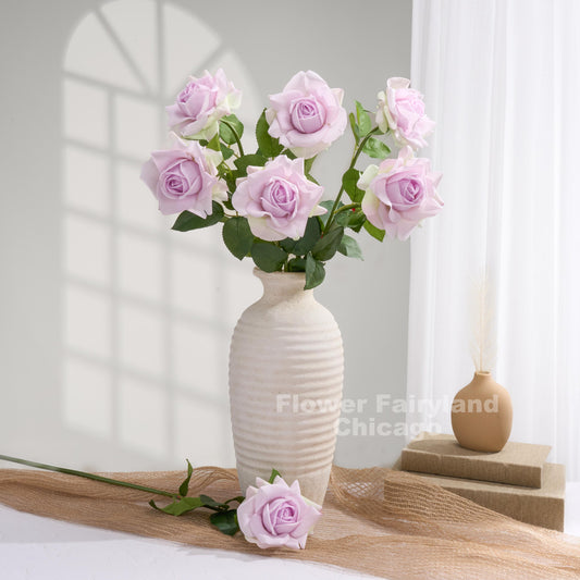 Soft purple roses styled in a vase
