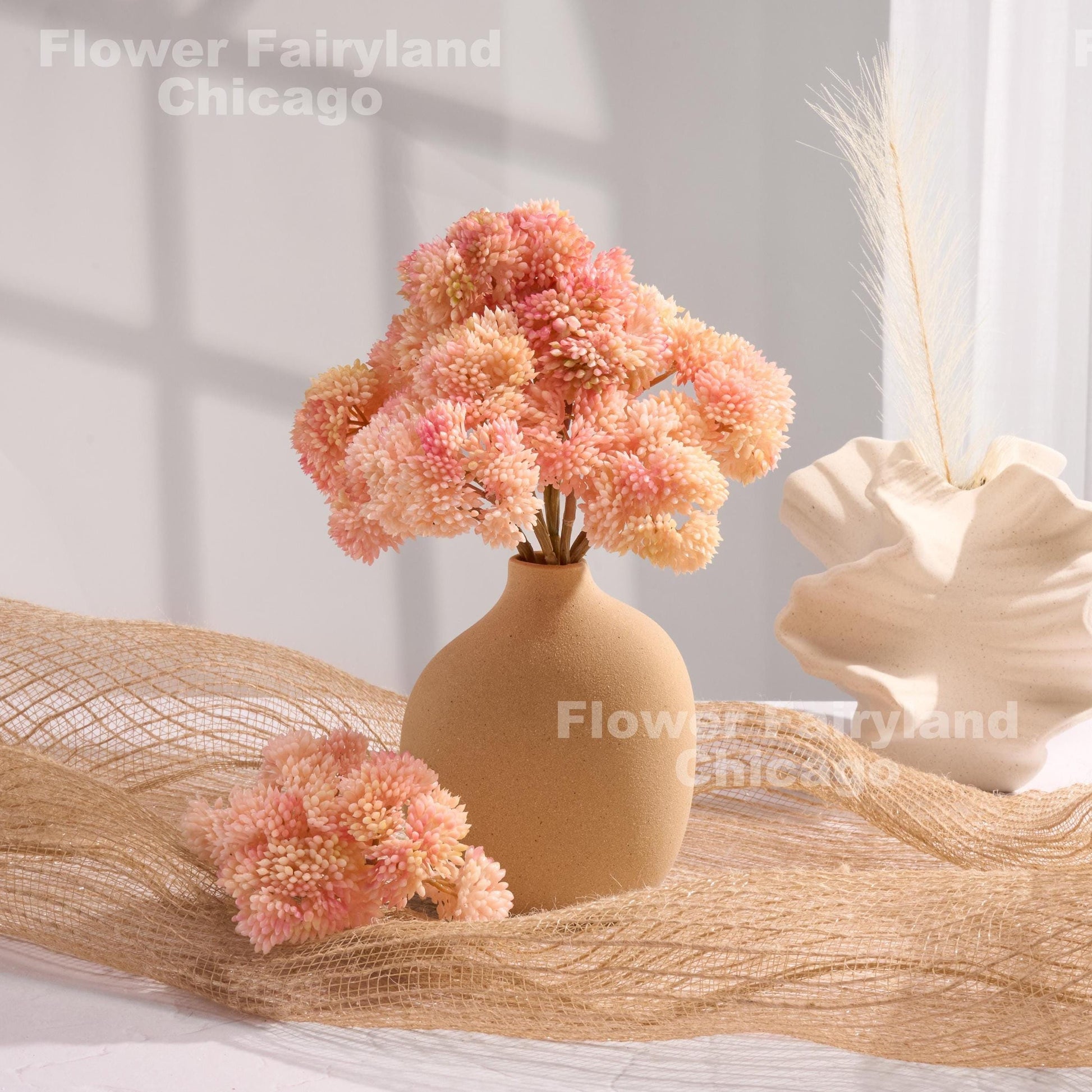 Light pink sedum clusters styled in a vase