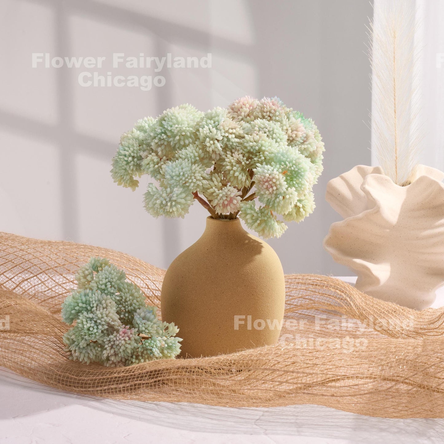 Light blue sedum cluster arrangement in a vase