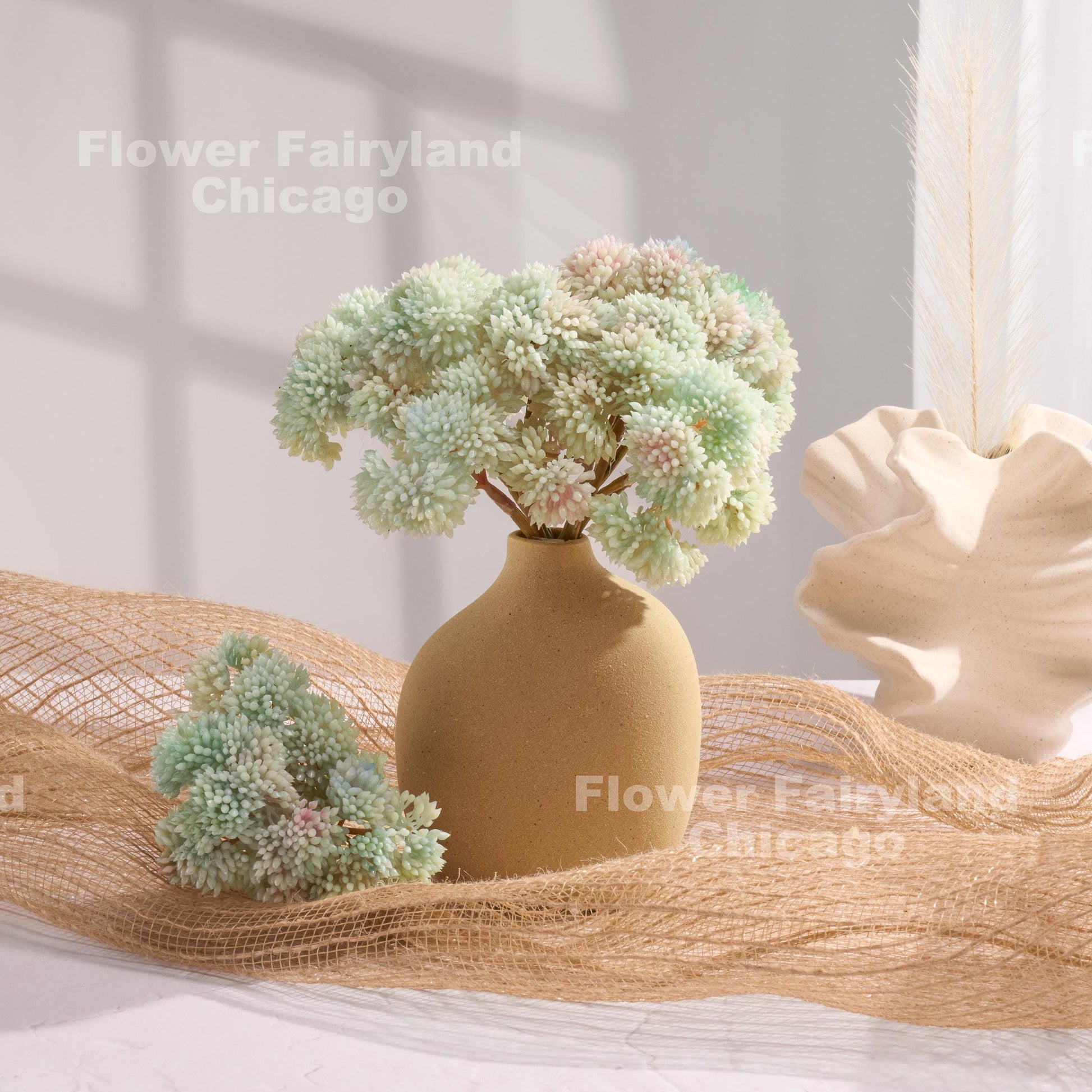 Light blue sedum cluster arrangement in a vase