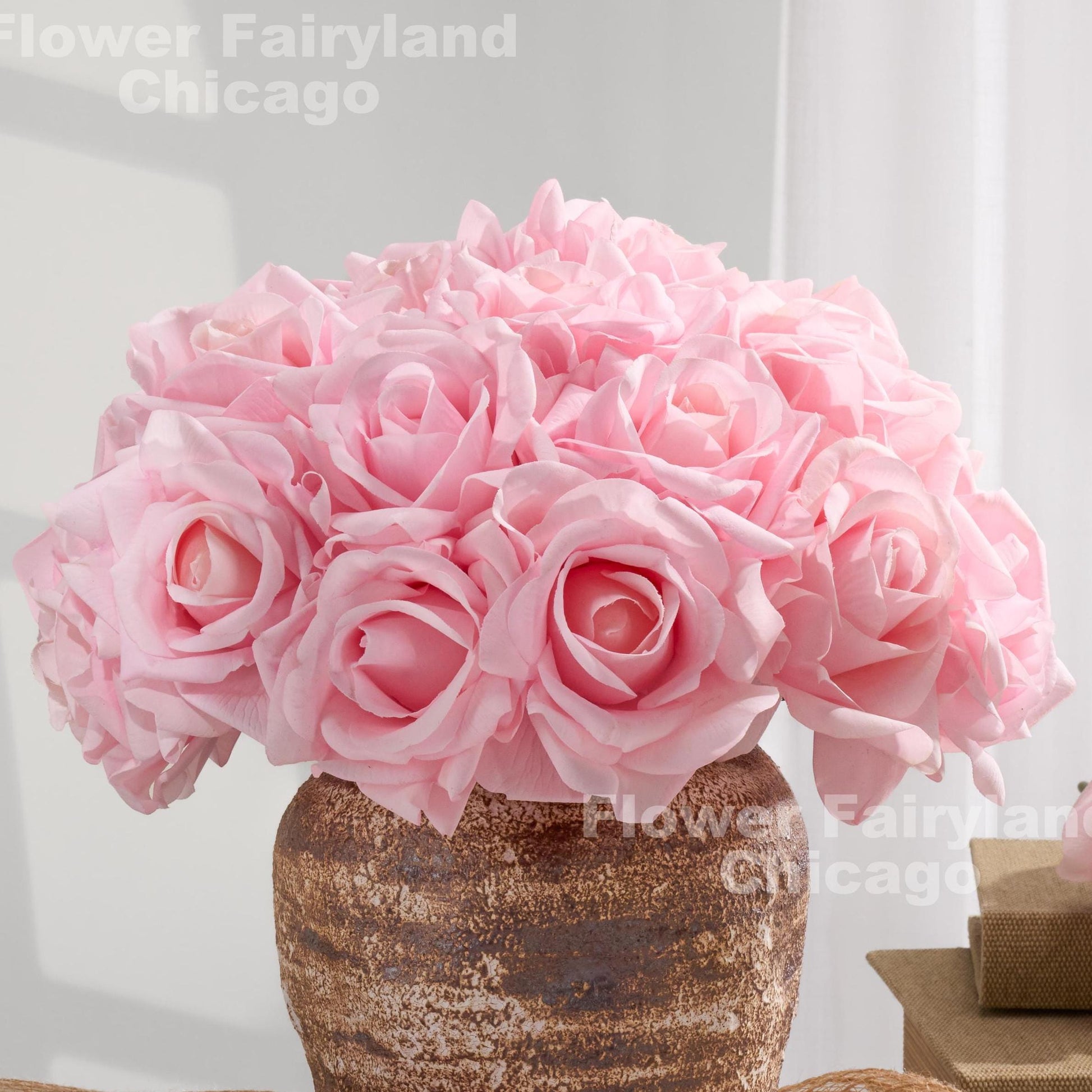Pink real touch roses in vase arrangement