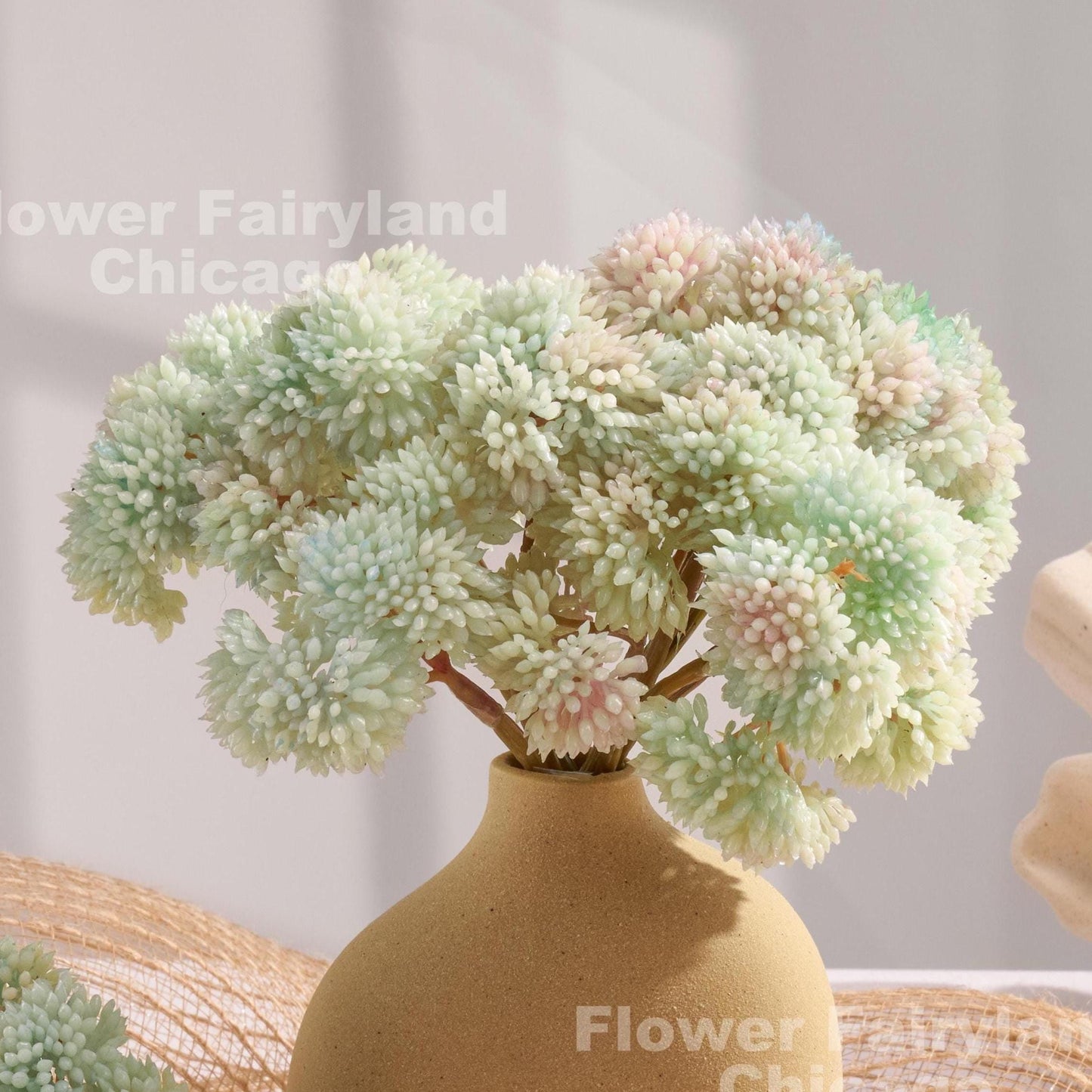 Light blue sedum clusters styled in a vase