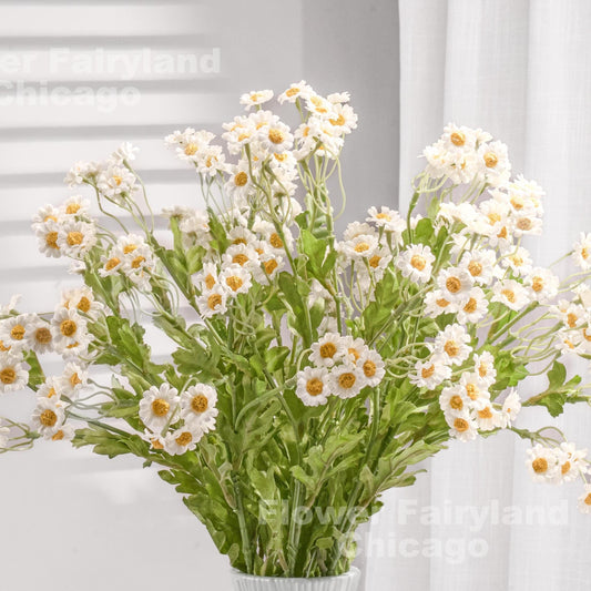 Bright white faux chamomile styled in a vase