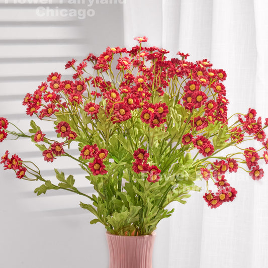 Red faux chamomile styled in a vase