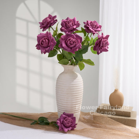 Plum roses styled in a cream vase