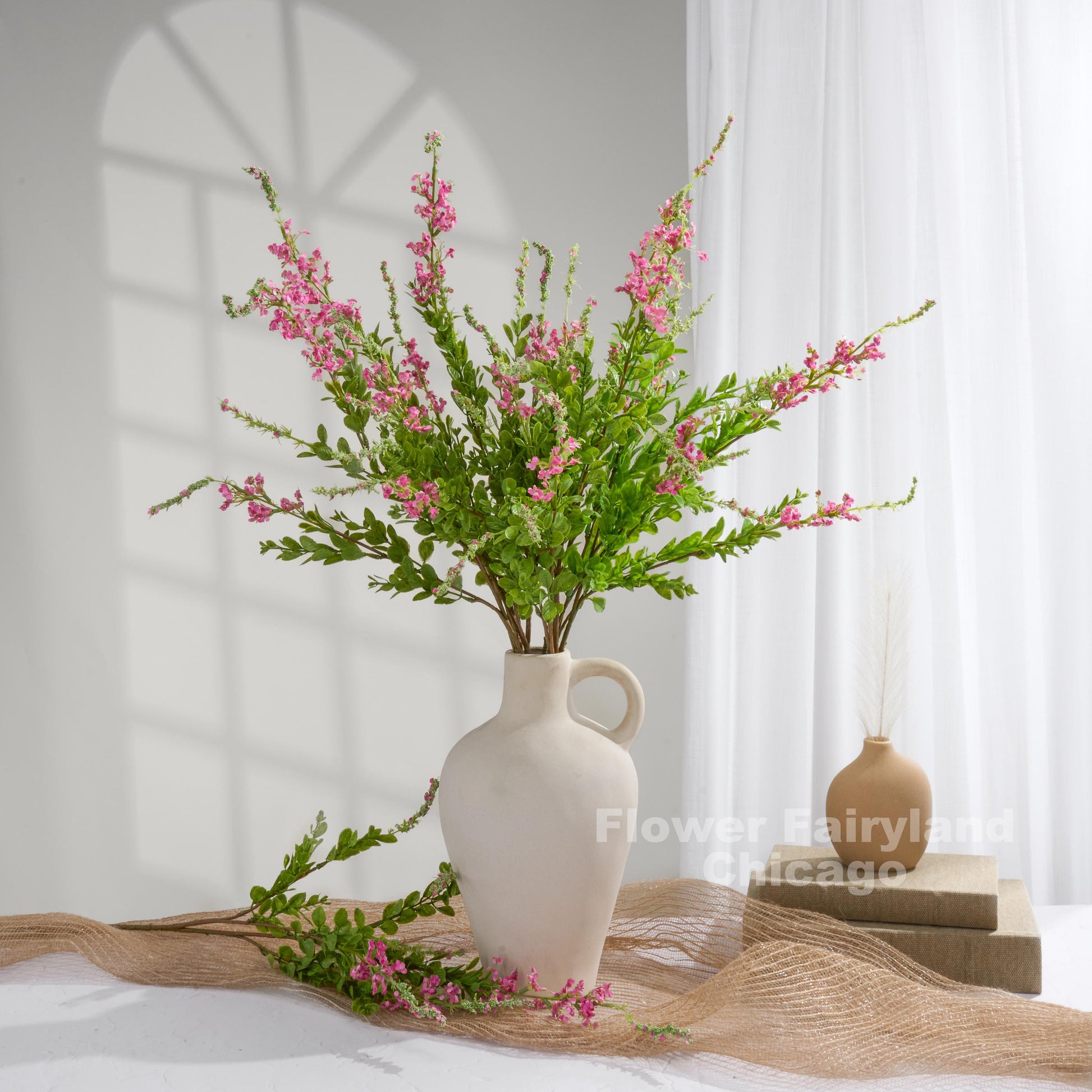 Deep pink sage branches styled in vase
