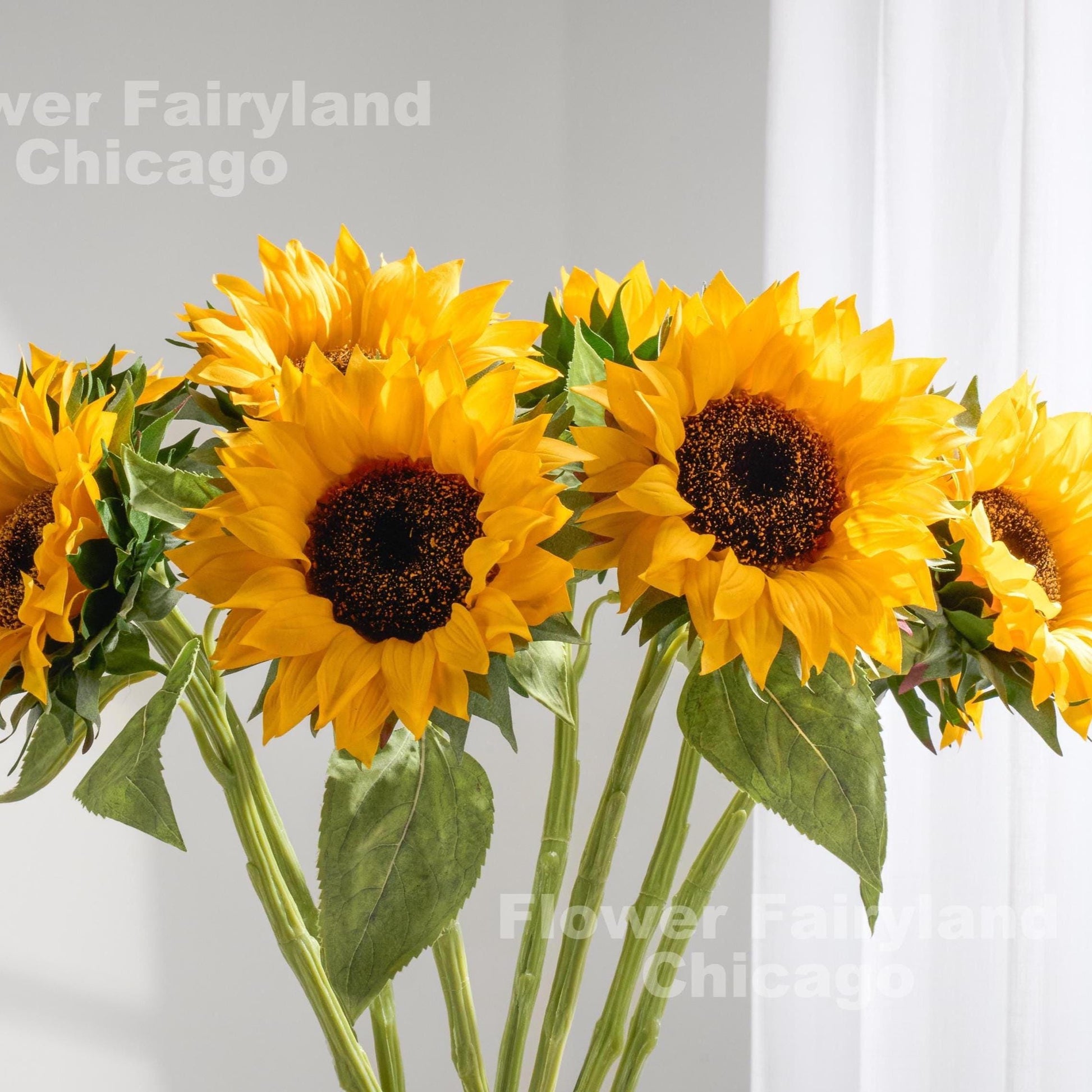 Yellow real touch sunflowers styled in a vase