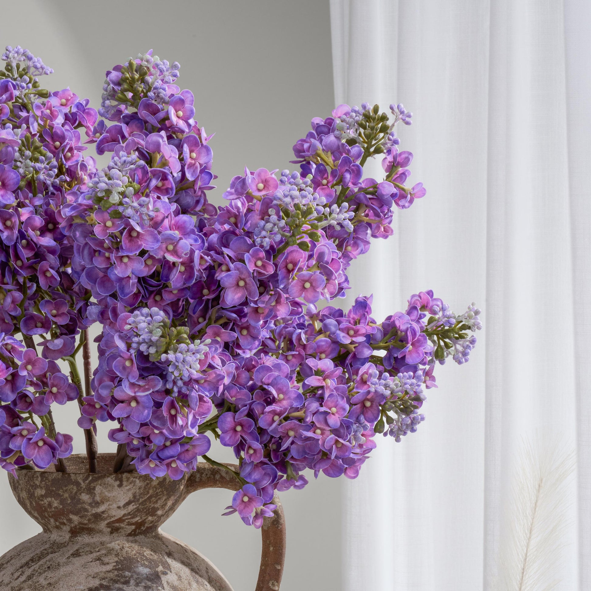Purple lilac arrangement in vase