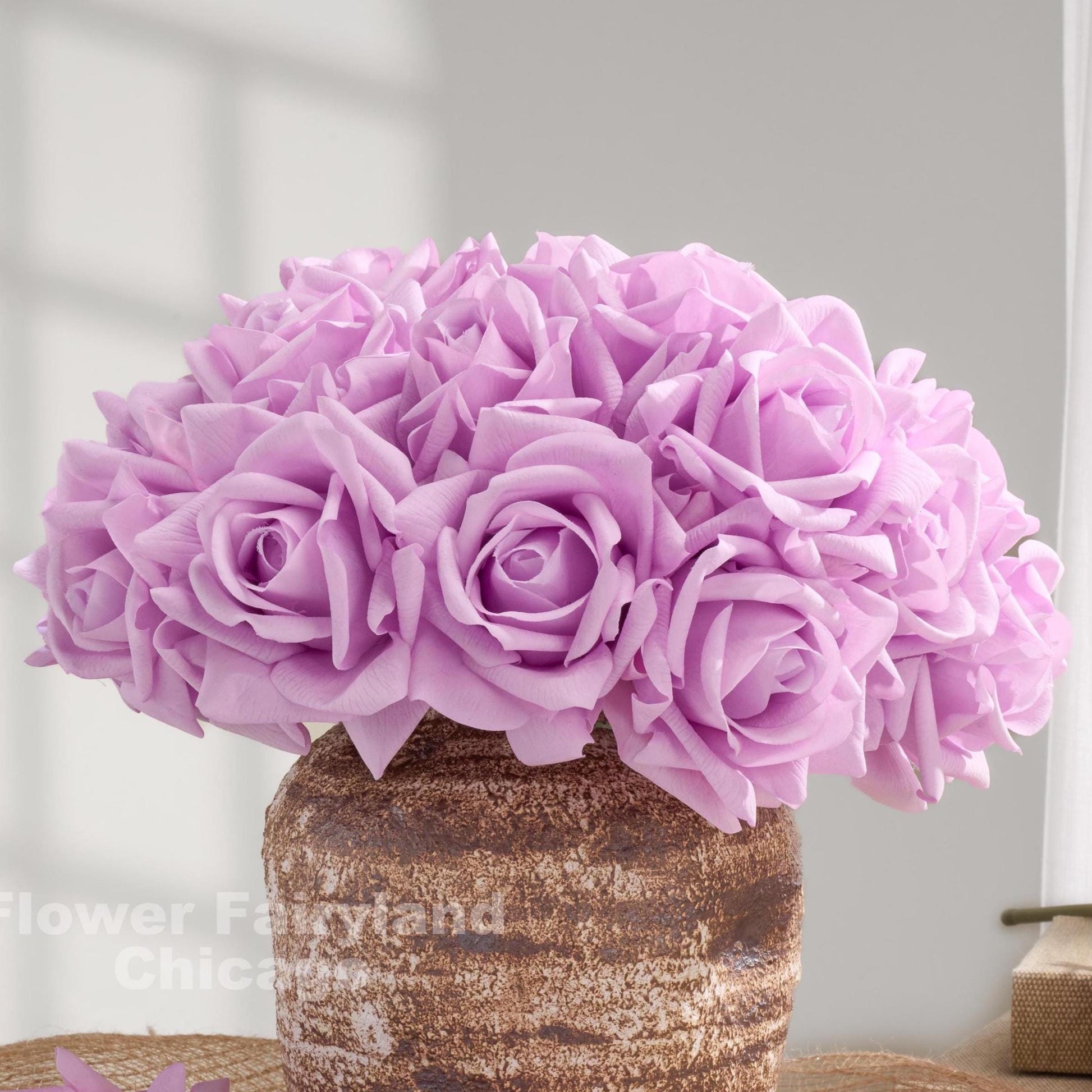 Lavender purple real touch rose bouquet in a vase