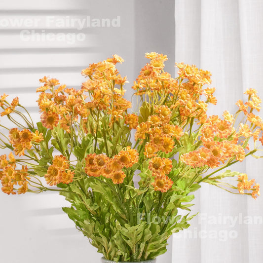 Orange faux chamomile styled in a vase