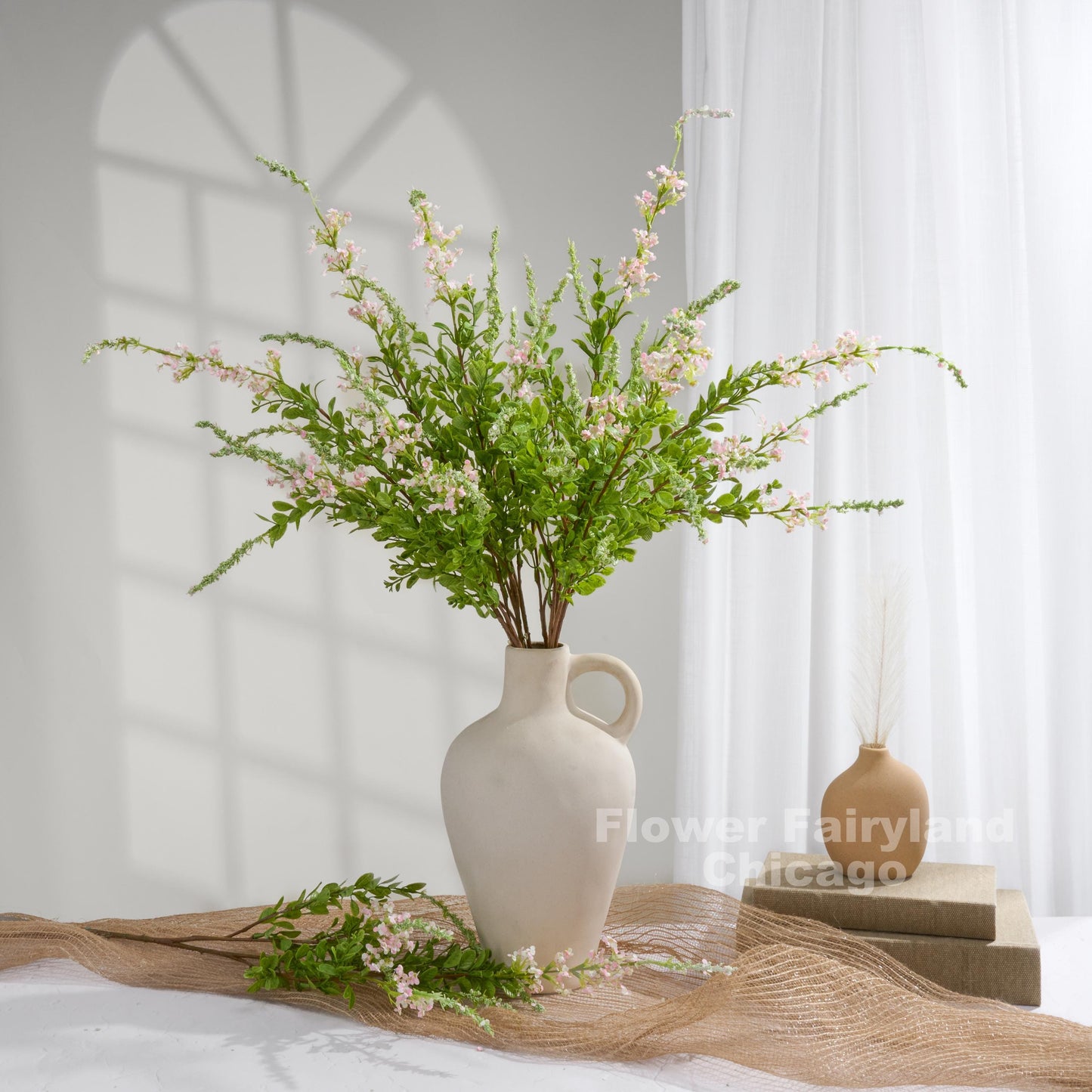 Light pink sage branches styled in vase