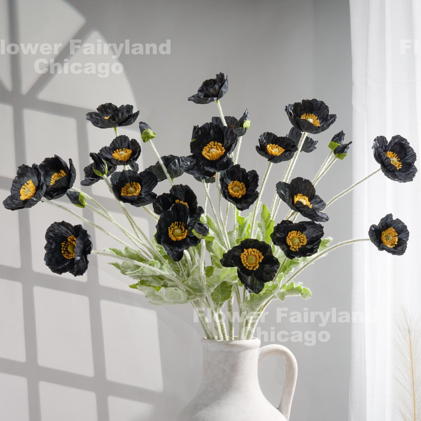 Black poppy arrangement in vase
