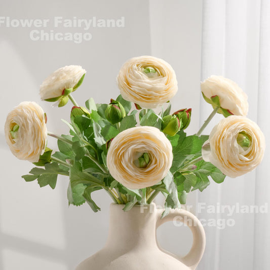 Milky white faux ranunculus stems in a vase