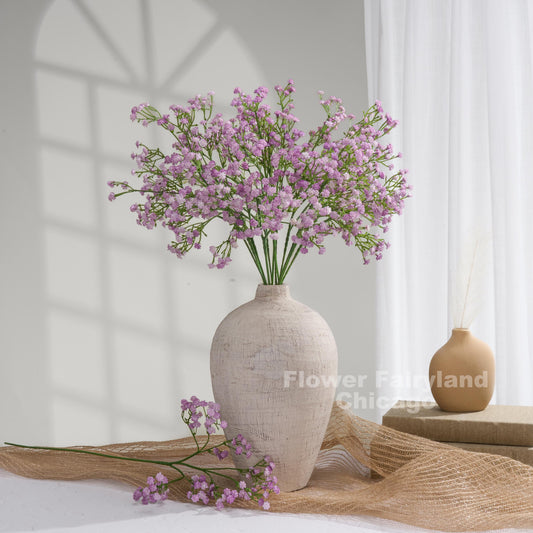 Faux baby's breath stems in light purple styled in a vase