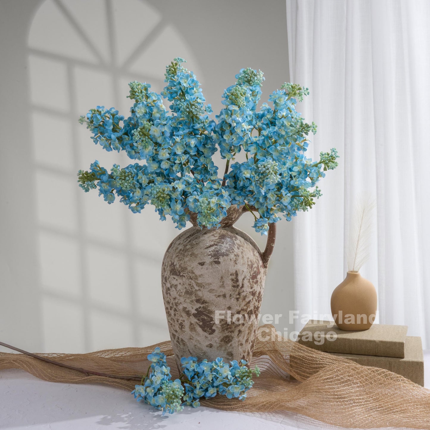 Aqua blue lilac arrangement in vase