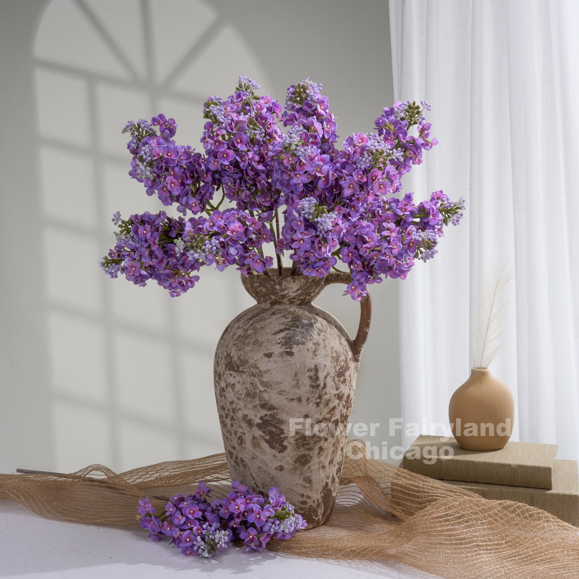 Purple real touch lilac stems in a vase