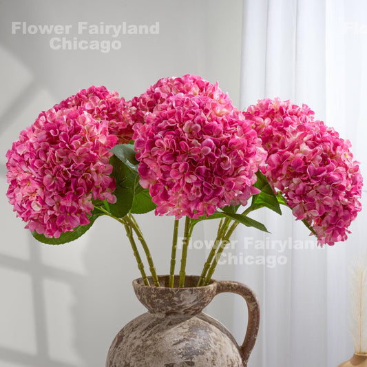 Bright pink faux hydrangea arrangement in a vase