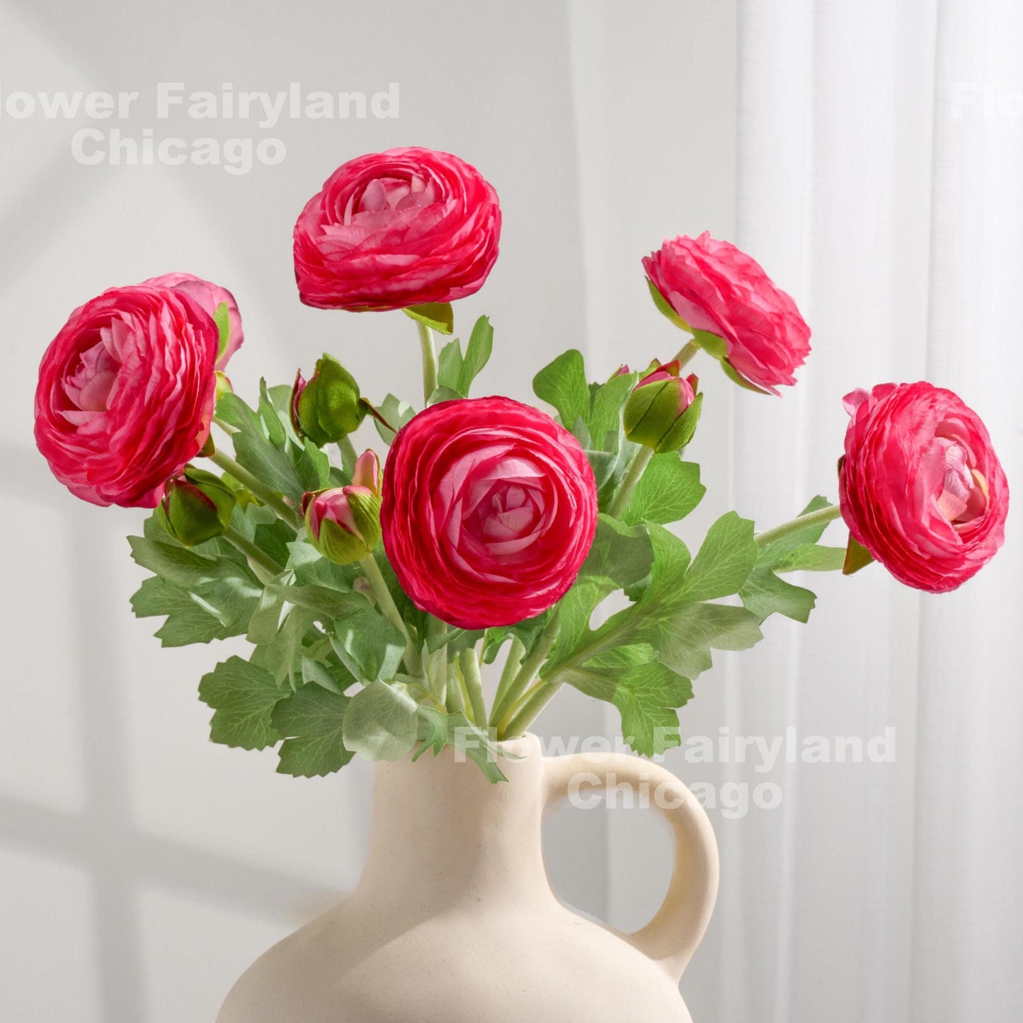 Dark pink faux ranunculus stems in a vase
